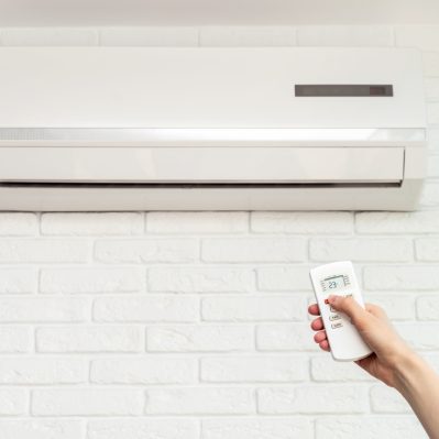 home air conditioner and hand with remote control