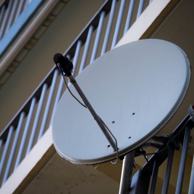 Vertical shot of a satellite antenna on a residential building
